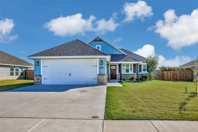 craftsman inspired home featuring a garage and a front lawn