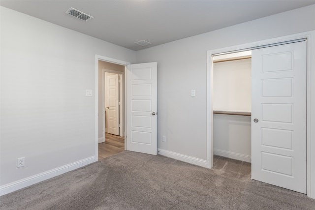 unfurnished bedroom featuring a closet and carpet flooring