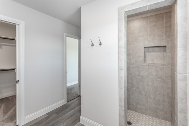 bathroom featuring tiled shower and hardwood / wood-style floors