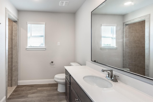 113 Bailey Ranch Dr, Lindsay, TX 76240 - full bathroom with toilet, wood finished floors, vanity, baseboards, and a tile shower