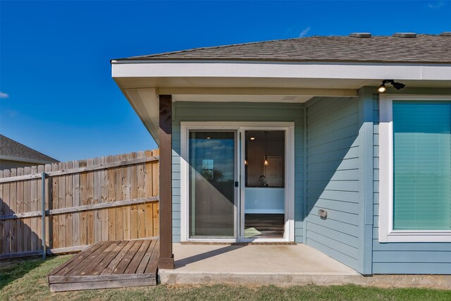 113 Bailey Ranch Dr, Lindsay, TX 76240 - doorway to property with fence, a patio area, and a shingled roof