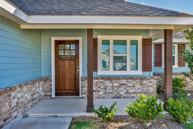 view of exterior entry with covered porch