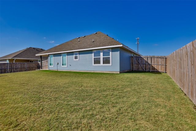 rear view of house featuring a lawn