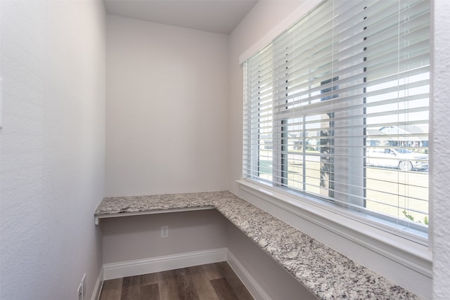 interior space featuring built in desk and hardwood / wood-style flooring