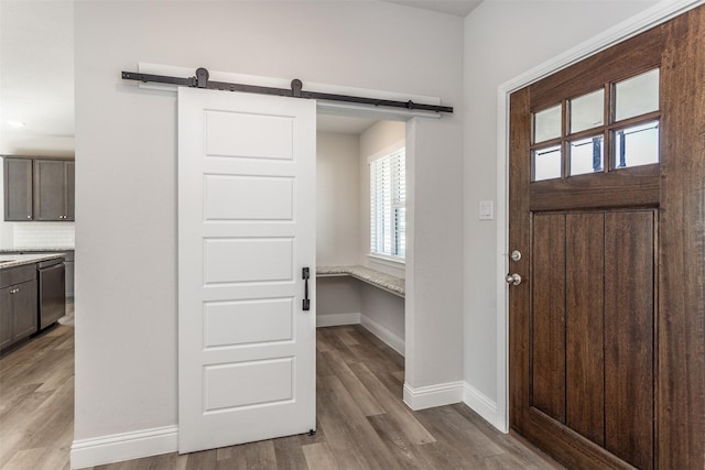 113 Bailey Ranch Dr, Lindsay, TX 76240 - foyer entrance featuring wood finished floors, a barn door, and baseboards