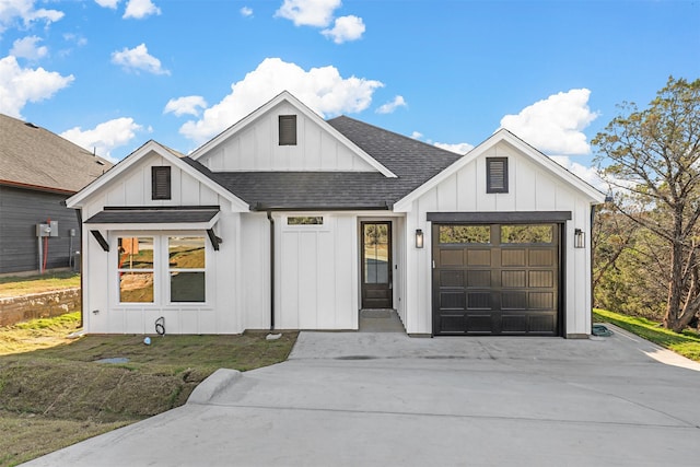 modern inspired farmhouse featuring a front yard and a garage