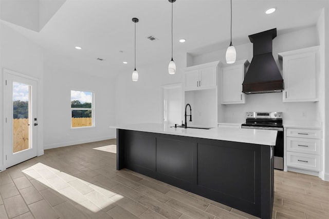 kitchen with custom exhaust hood, white cabinets, an island with sink, electric stove, and sink