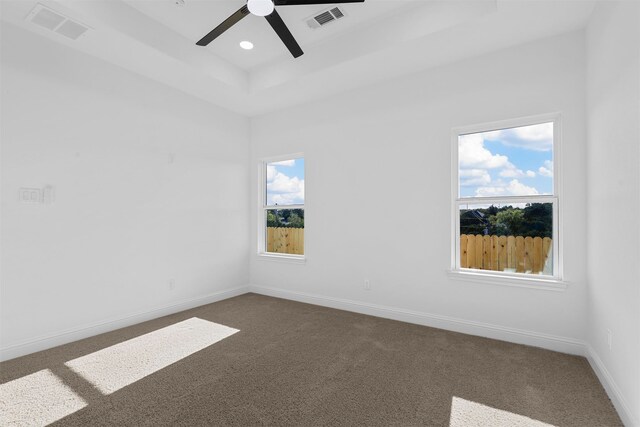 carpeted spare room featuring ceiling fan