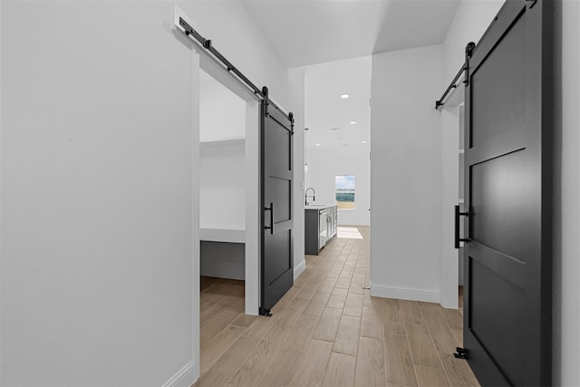 hallway featuring light hardwood / wood-style flooring and sink