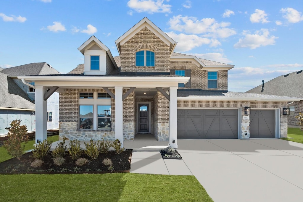 view of front of house featuring an attached garage, stone siding, concrete driveway, and brick siding