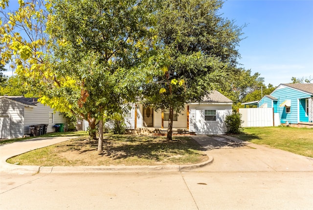 obstructed view of property featuring a front lawn