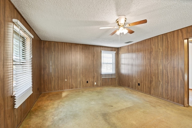 112 Crocker Rd, Malakoff, TX 75148 - carpeted empty room with a textured ceiling, ceiling fan, and wood walls