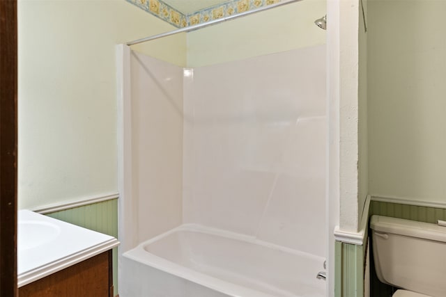 full bathroom featuring vanity, bathing tub / shower combination, and toilet