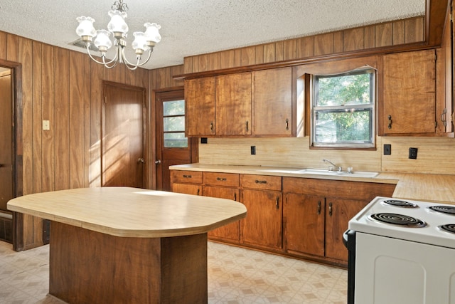 112 Crocker Rd, Malakoff, TX 75148 - kitchen featuring light flooring, light countertops, a chandelier, a textured ceiling, and wood walls