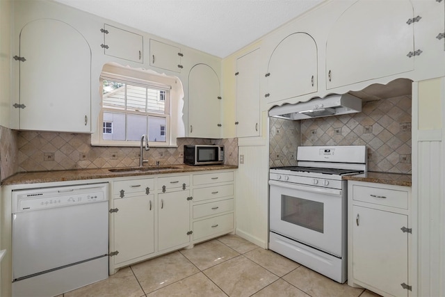 kitchen featuring white appliances, sink, custom exhaust hood, and white cabinets