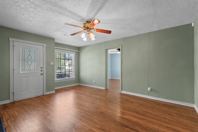 entryway featuring wood-type flooring, a textured ceiling, and ceiling fan