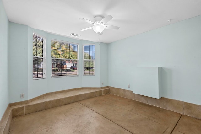 unfurnished room featuring concrete flooring and ceiling fan