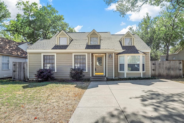 new england style home featuring a front yard