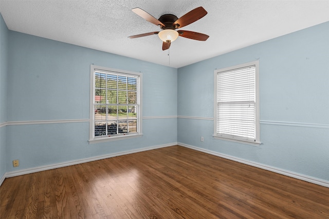 empty room featuring ceiling fan, hardwood / wood-style floors, and a textured ceiling