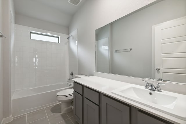 full bathroom featuring tiled shower / bath, vanity, toilet, and tile patterned flooring