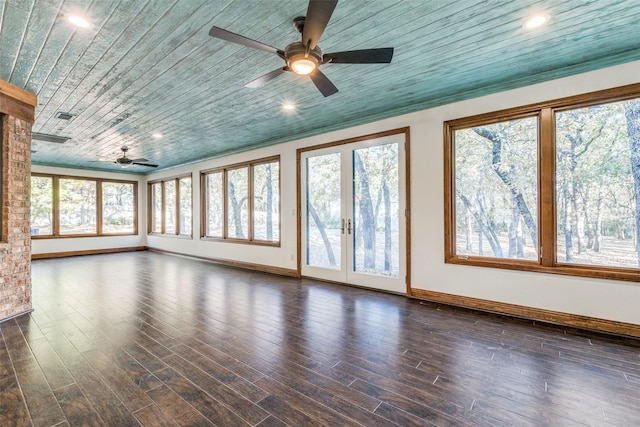 unfurnished living room featuring dark hardwood / wood-style floors and a wealth of natural light