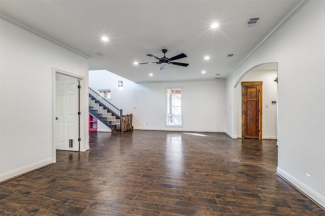 unfurnished living room with ornamental molding, dark wood-type flooring, and ceiling fan