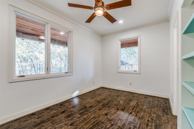 empty room with crown molding, a healthy amount of sunlight, and dark hardwood / wood-style flooring