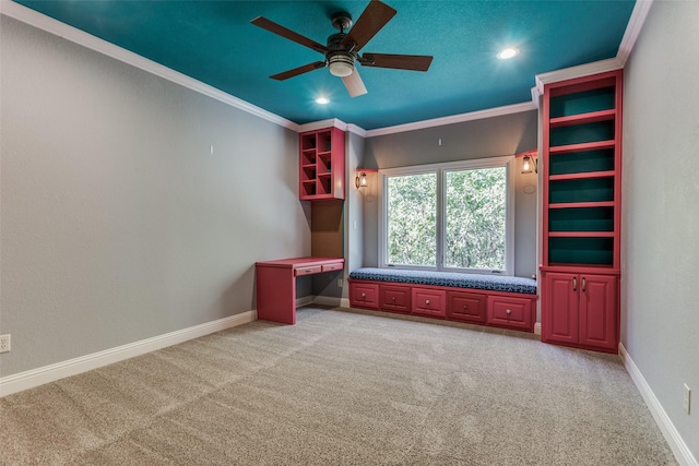 interior space featuring carpet floors, ceiling fan, and crown molding