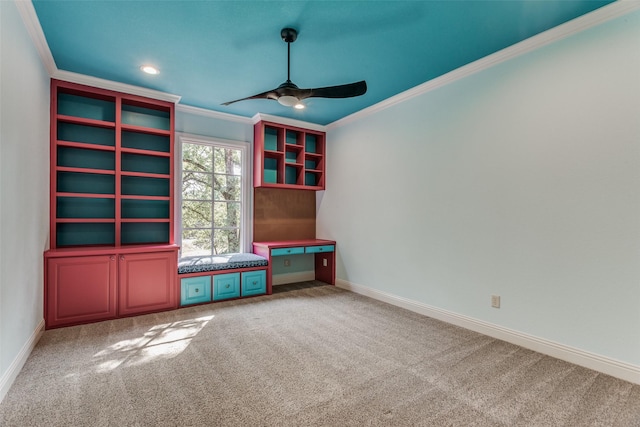 interior space with carpet, ceiling fan, and crown molding