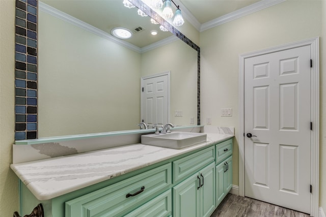 bathroom featuring vanity, hardwood / wood-style flooring, and ornamental molding