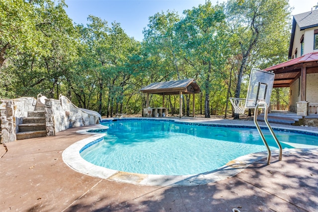 view of swimming pool with a gazebo, a patio area, and a water slide