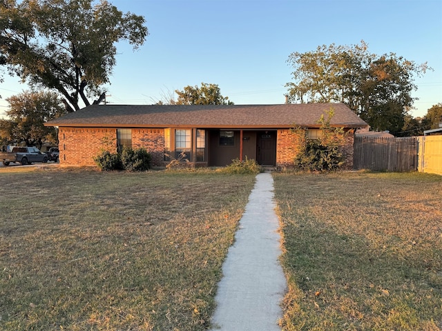 ranch-style home with a front lawn