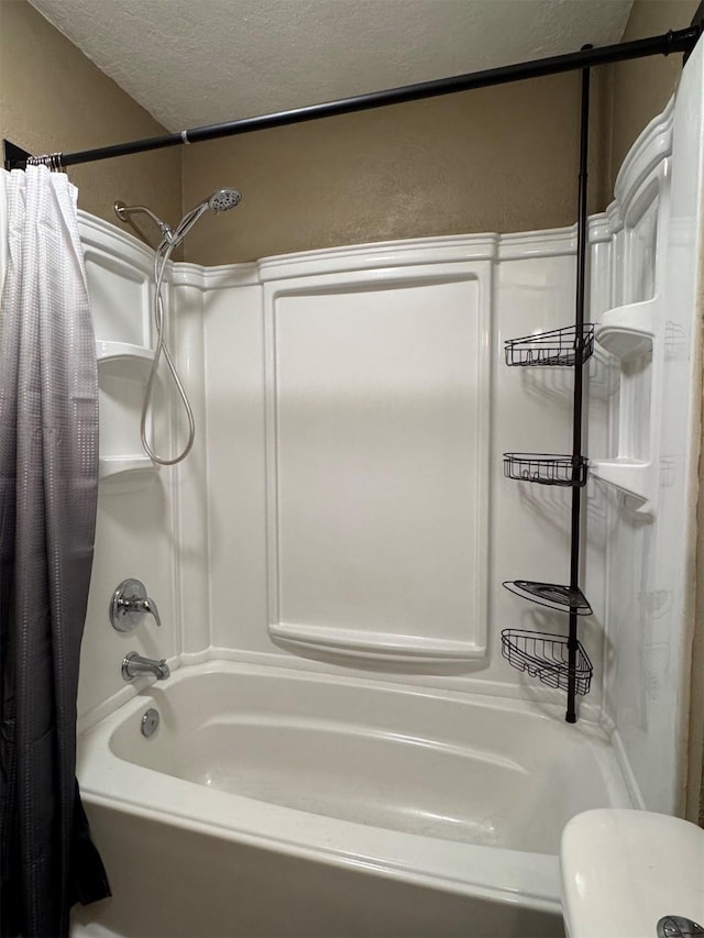 bathroom with shower / tub combo and a textured ceiling