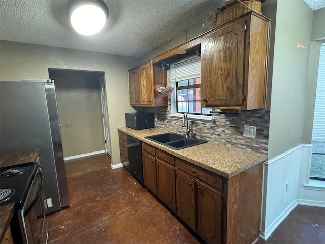 kitchen with black appliances, backsplash, sink, and a textured ceiling