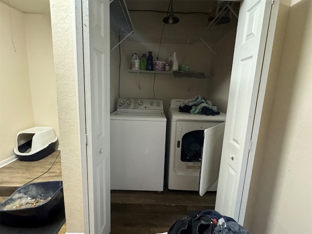 laundry area with washer and dryer and dark hardwood / wood-style flooring