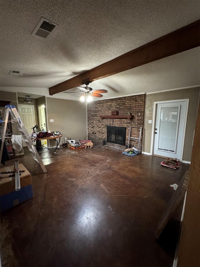 living room with beamed ceiling, a fireplace, ceiling fan, and a textured ceiling