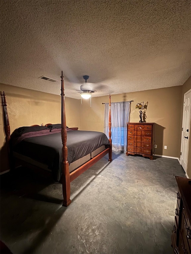 bedroom featuring a textured ceiling, ceiling fan, and concrete floors