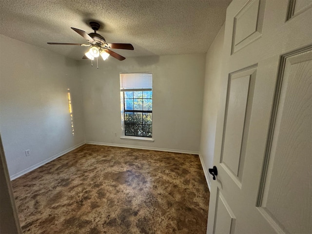 carpeted spare room featuring ceiling fan and a textured ceiling