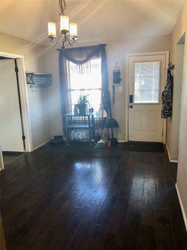 entrance foyer with a chandelier and dark hardwood / wood-style floors