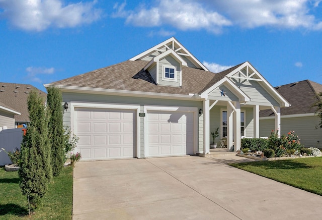 view of front of home with a front yard and a garage