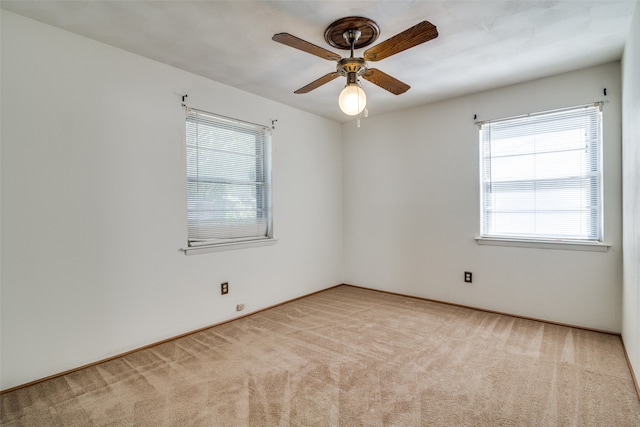 carpeted empty room featuring ceiling fan