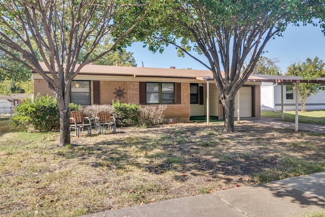 ranch-style home featuring a garage and a front lawn