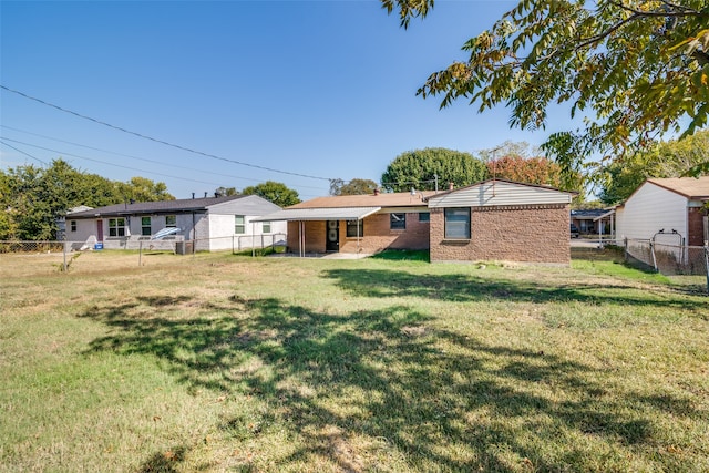 rear view of property with a yard