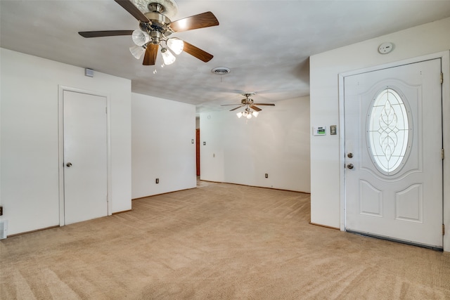 carpeted entryway with ceiling fan