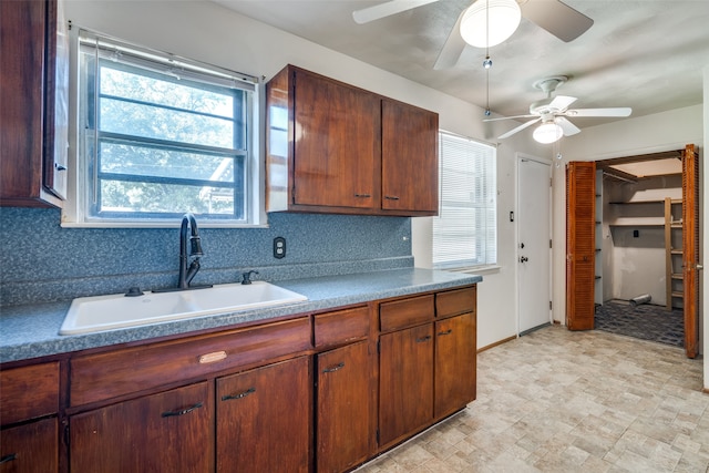 kitchen featuring sink, decorative backsplash, and ceiling fan