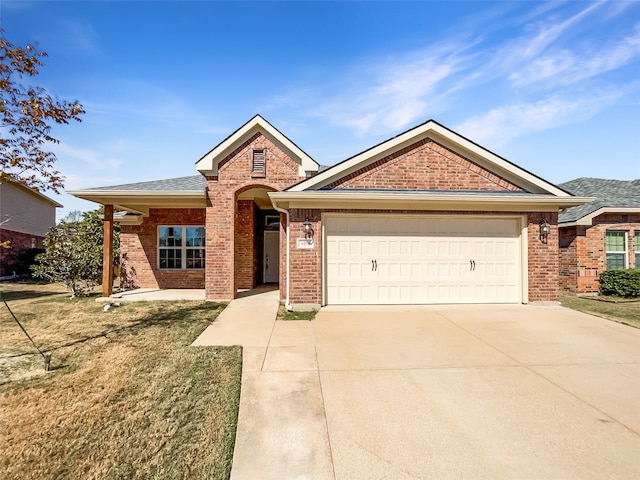 view of front of home with a front lawn and a garage