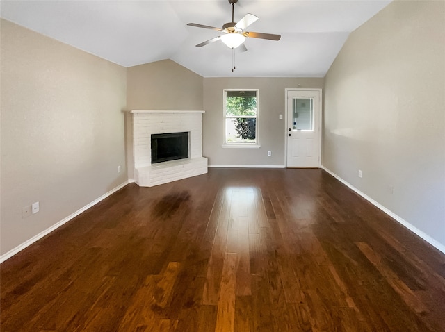 unfurnished living room featuring ceiling fan, dark wood-type flooring, a fireplace, and vaulted ceiling