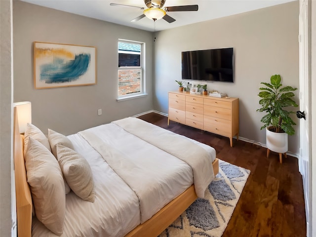 bedroom with dark hardwood / wood-style flooring and ceiling fan