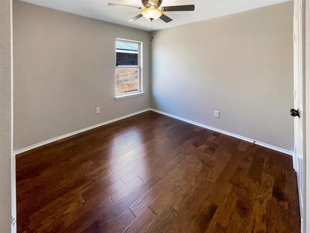 spare room with ceiling fan and dark hardwood / wood-style flooring