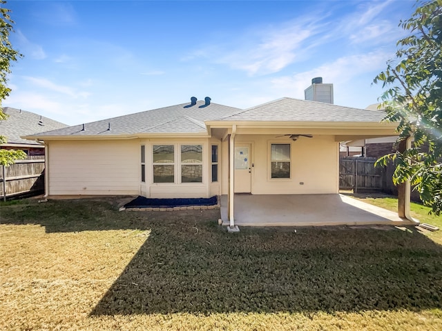 back of property with a patio area, a lawn, and ceiling fan